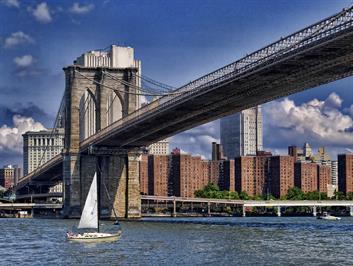A unique photo of the Brooklyn Bridge with sailboat